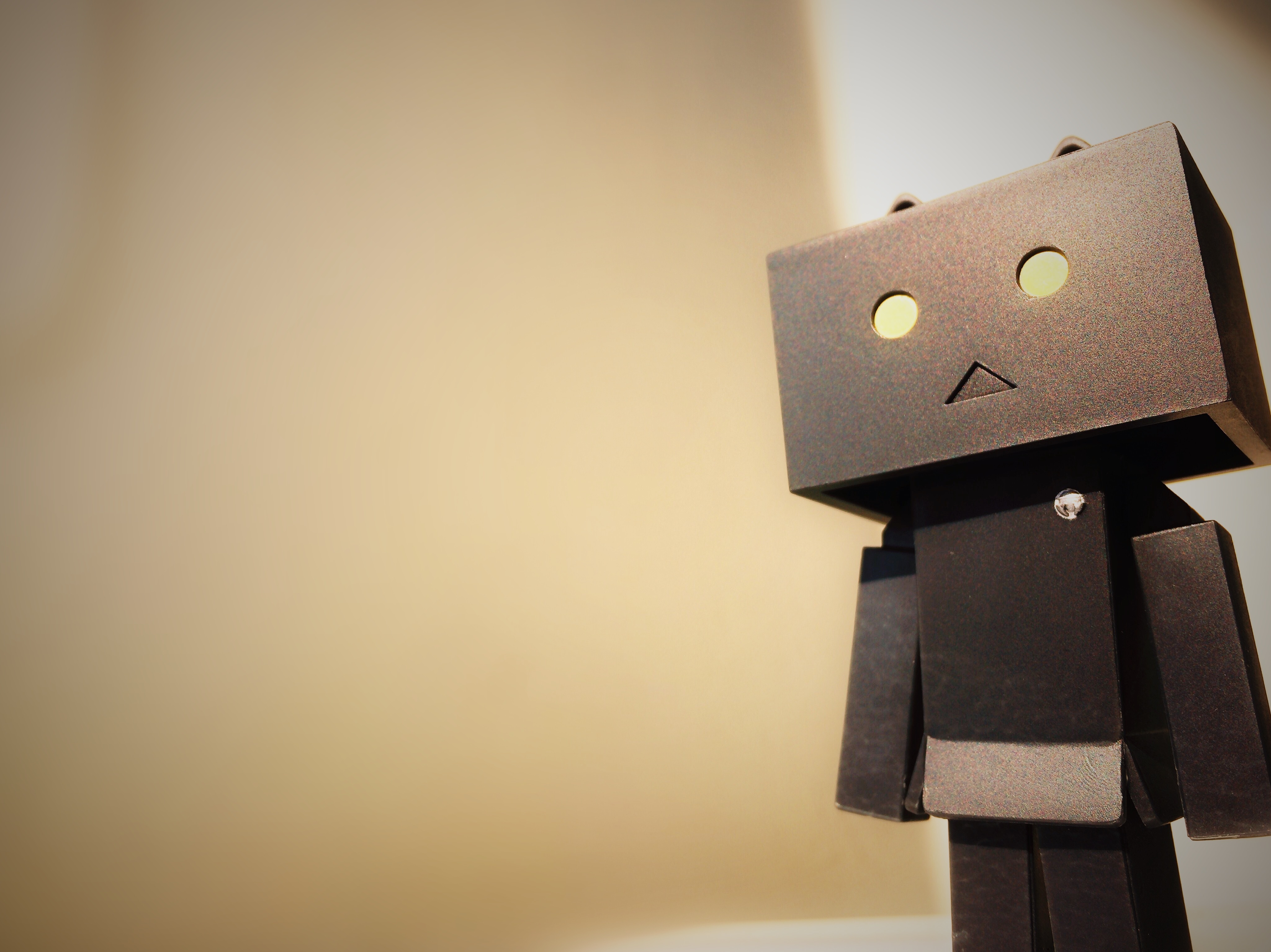 Cardboard robot thinking about how to become more creative and productive